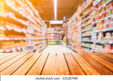 Wooden board empty table in front of blurred background. Perspective light wood over blur in supermarket - can be used for display or montage your products. Mock up for display of product.
