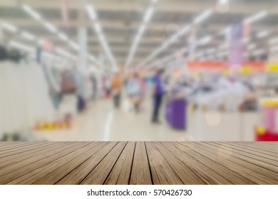 Wooden board empty table in front of blurred background. Perspective light wood over blur in supermarket - can be used for display or montage your products. Mock up for display of product.
