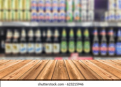 Wooden board empty table in front of blurred background. Perspective alcohol bottle on Shelf in Supermarket can be used for display or montage your products - Powered by Shutterstock