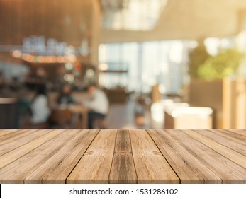 Wooden board empty table top on of blurred background. Perspective brown wood table over blur in coffee shop background - can be used mock up for montage products display or design key visual layout. - Shutterstock ID 1531286102