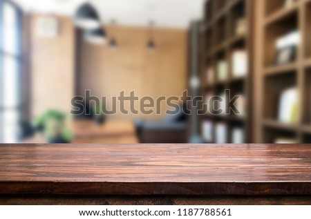 Wooden board empty Table Top And Blur Interior over blur in coffee shop Background, Mock up for display of product.
