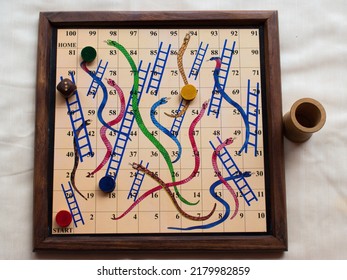 Wooden Board game Snake and ladder. Toy play child. game for four players. Indoor game. Invented in India.  - Shutterstock ID 2179982859