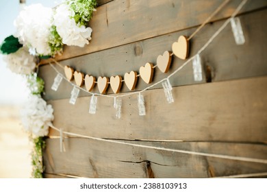 Wooden board with heart shaped garland and string lights - wedding welcome sign - Powered by Shutterstock