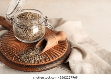 Wooden board with jar of dried anise seeds and scoop on light background - Powered by Shutterstock