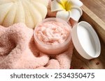 Wooden board with natural body scrub, clean towel and bath sponge, closeup