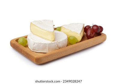 Wooden board with pieces of tasty Camembert cheese on white background