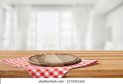 Wooden board stand on tablecloth over grunge background