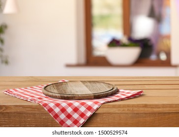 Wooden Board Stand On Tablecloth Over Grunge Background