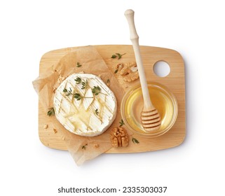 Wooden board of tasty baked Camembert cheese with honey on white background - Powered by Shutterstock