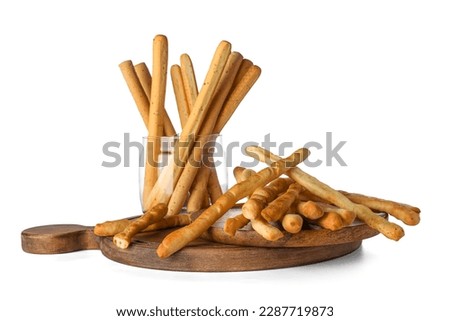 Wooden board with tasty Italian Grissini isolated on white background