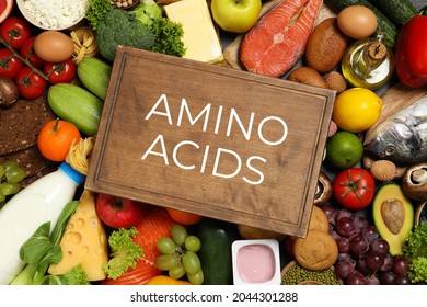 Wooden board with text AMINO ACIDS among different products, top view  - Shutterstock ID 2044301288
