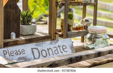 Wooden Board With Word Donation And Glass Money Jar