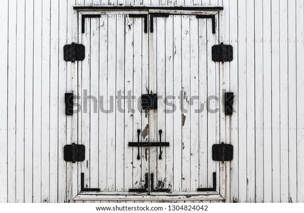 Wooden boards painted in white. Old\
white background. Metal door wooden freight railway wagon. Texture\
of wooden background carriage of the train. Line\
boards.