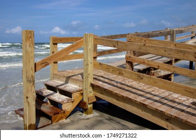 Wooden boardwalk steps give walkover access to beach. - Shutterstock ID 1749271322