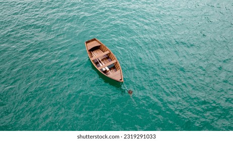 A wooden boat floating serenely on the blue-green lake is a sight that soothes the soul. - Powered by Shutterstock