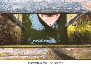 A Wooden Boat Floats Under The Bridge. View From Above.