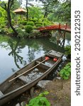 A wooden boat in the forest of Shukkeien Garden in Hiroshima, Japan