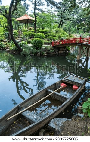 A wooden boat in the forest of Shukkeien Garden in Hiroshima, Japan