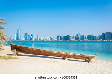 Wooden boat at the Heritage Village, in front of the Abu Dhabi skyline, United Arab Emirates - Powered by Shutterstock