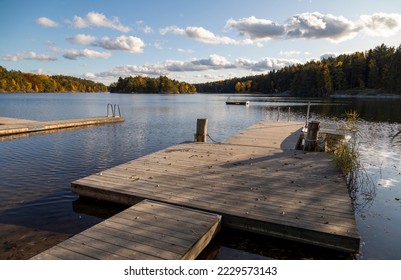 Wooden boat jetty on the lake in autumn day