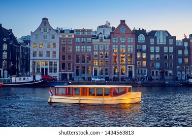 Wooden Boat On The Canal In Amsterdam During Sunset