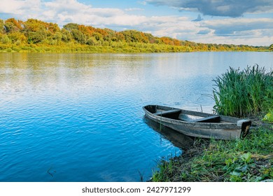 Wooden boat on the river bank - Powered by Shutterstock