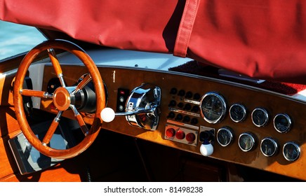 Wooden boat with steering wheel and dashboard