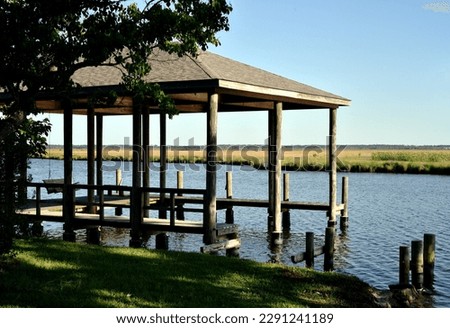 Similar – Image, Stock Photo Wooden boathouses built on the Mecklenburg Lake District on the banks of the Müritz River