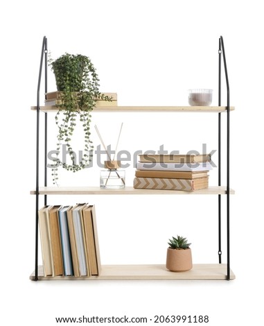 Wooden book shelf with decor on white background