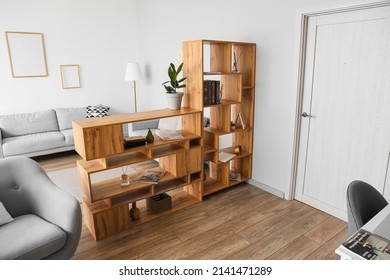 Wooden bookcase in interior of modern living room - Shutterstock ID 2141471289