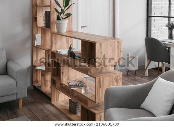 Wooden\
bookcase in interior of modern living\
room