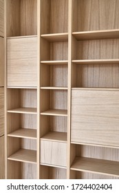 Wooden bookshelves. Wooden bookcases and wall panels made of oak veneered MDF. Close-up