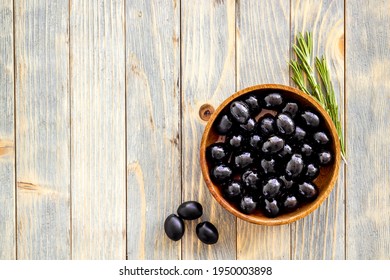 Wooden Bowl With Black Olives. Overhead View, Space For Text