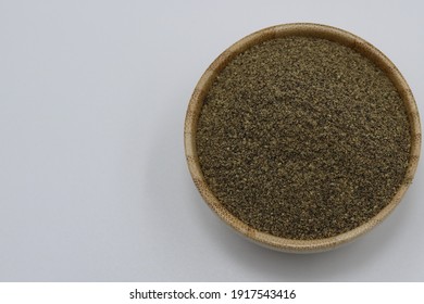 Wooden Bowl Of Black Pepper Powder.