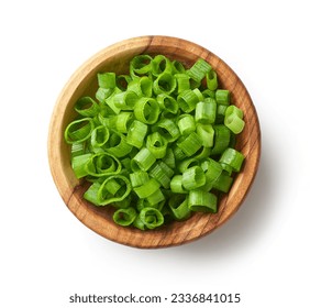 wooden bowl of chopped green onions isolated on white background, top view
