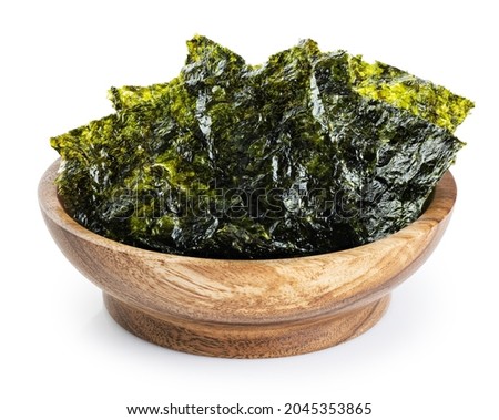 Wooden bowl with crispy nori seaweed korean snack isolated on white background. With clipping path.