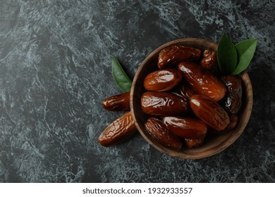 Wooden Bowl Of Dates On Black Smokey Background