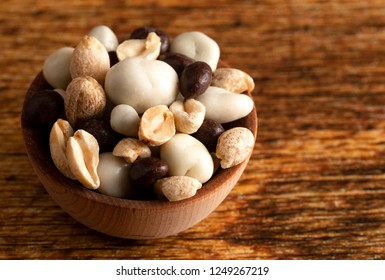 A Wooden Bowl Filled With Healthy Trail Mix