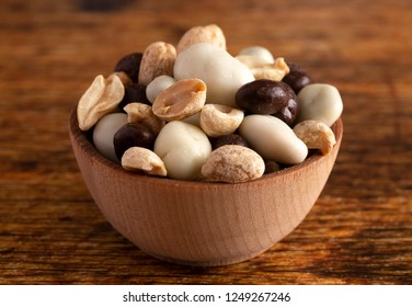 A Wooden Bowl Filled With Healthy Trail Mix