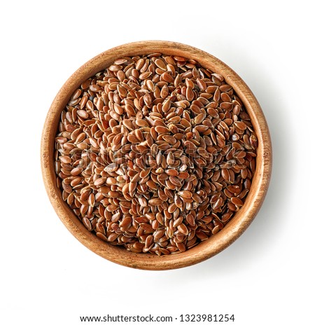 wooden bowl of flaxseed isolated on white background, top view