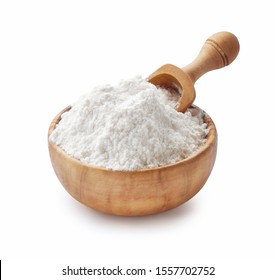 Wooden Bowl with flour and flour spoon. Rice or wheat flour isolated on white background.