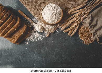 Wooden bowl with flour and wheat ears, ingredients for a homemade dish. - Powered by Shutterstock