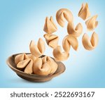 Wooden bowl with fortune cookie. Collage with flying fortune cookie with clipping path.