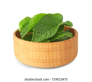 Wooden bowl with fresh mint leaves on white background - Powered by Shutterstock