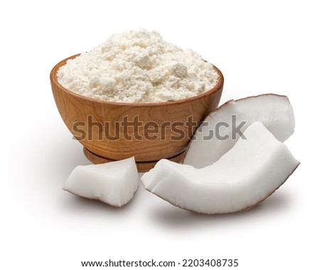 Wooden bowl full of coconut flour isolated on white