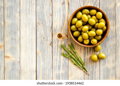 Wooden Bowl With Green Olives. Overhead View, Space For Text