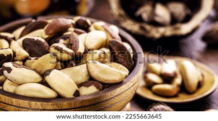 wooden bowl with many Bertholletia excelsa, popularly known as chestnut of the amazon, chestnut of acre, Brazil nut, bolivian walnut, tori or tururi, Brazillian tipical food
