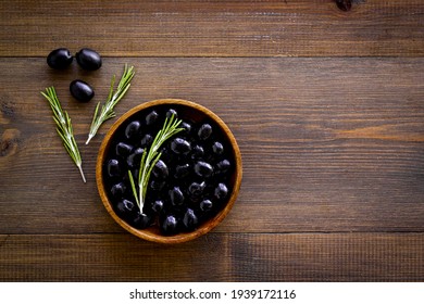 Wooden Bowl Of Pickled Black Olives, Top View