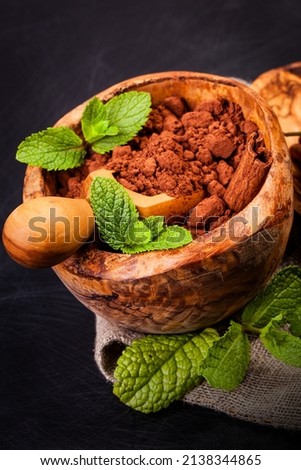 Ð¡ocoa  in wooden bowl and spices - cinnamon, cardamom, tubby. Candy set. 