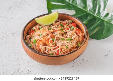 Wooden bowl of stir-fried pad thai dish - Powered by Shutterstock